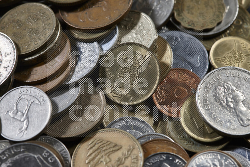 A close-ups of random old coins on black background