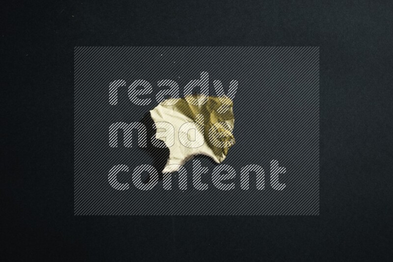 Burnt multicolored paper on black background