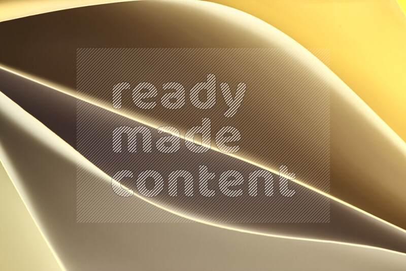 This image showcases an abstract paper art composition with paper curves in gold gradients created by colored light