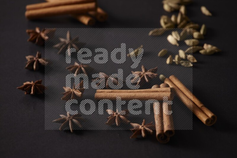 Cinnamon Sticks, Cardamom and star anise on a black background