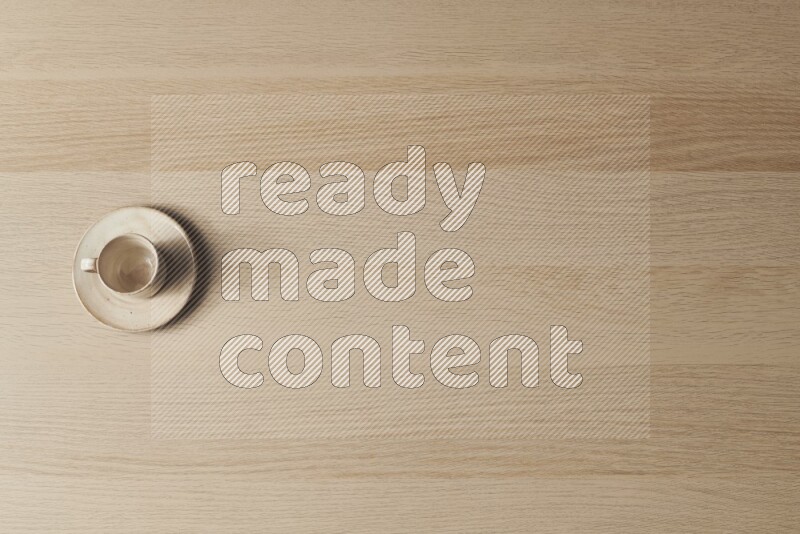 A pottery cup on light wooden background