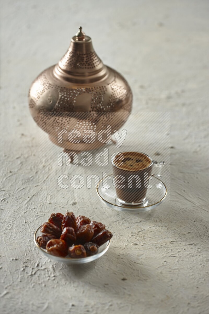 A golden lantern with different drinks, dates, nuts, prayer beads and quran on textured white background