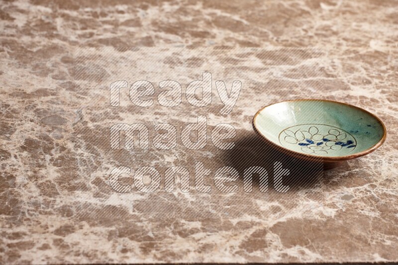 Decorative Pottery Plate on Beige Marble Flooring