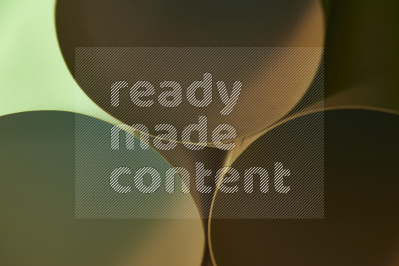 The image shows an abstract paper art with circular shapes in varying shades of green and warm tones