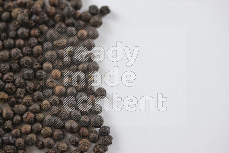 Black pepper beads on white background