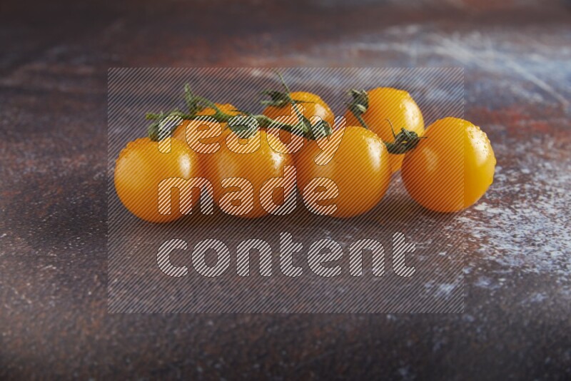 Yellow cherry tomato vein on reddish rustic metal background 45 degree