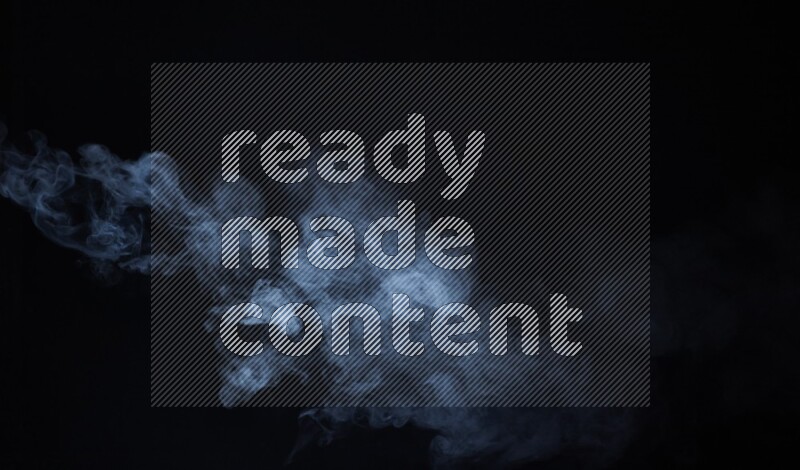 Heavy smoke in blue isolated on black background