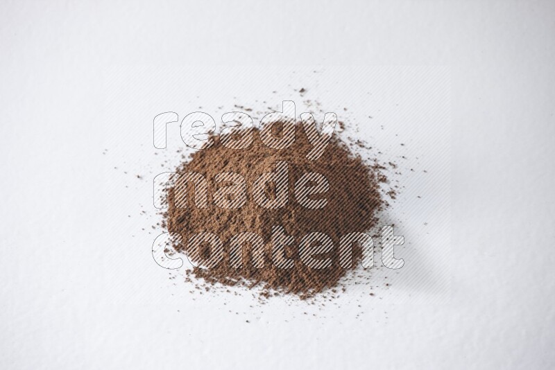 A pile of cloves powder on a white flooring