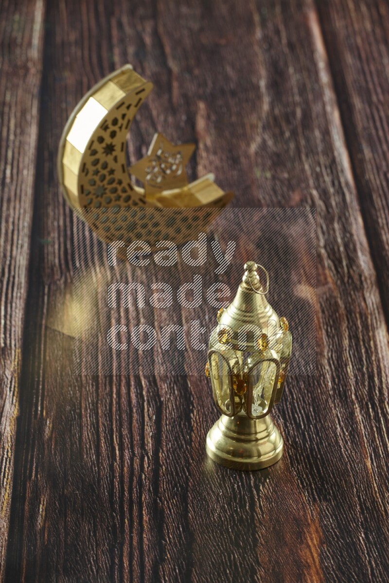 A wooden crescent lantern with classic ramadan lantern on brown wooden background