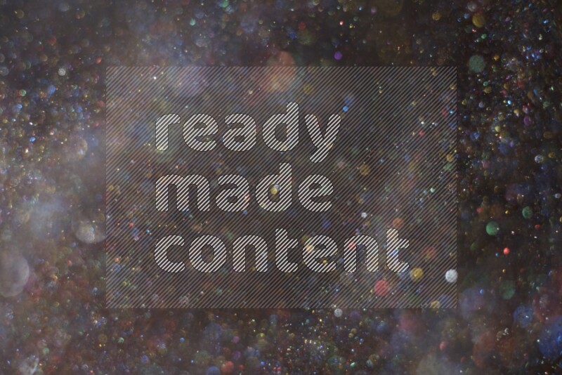 Multicolored glitter powder isolated on black background