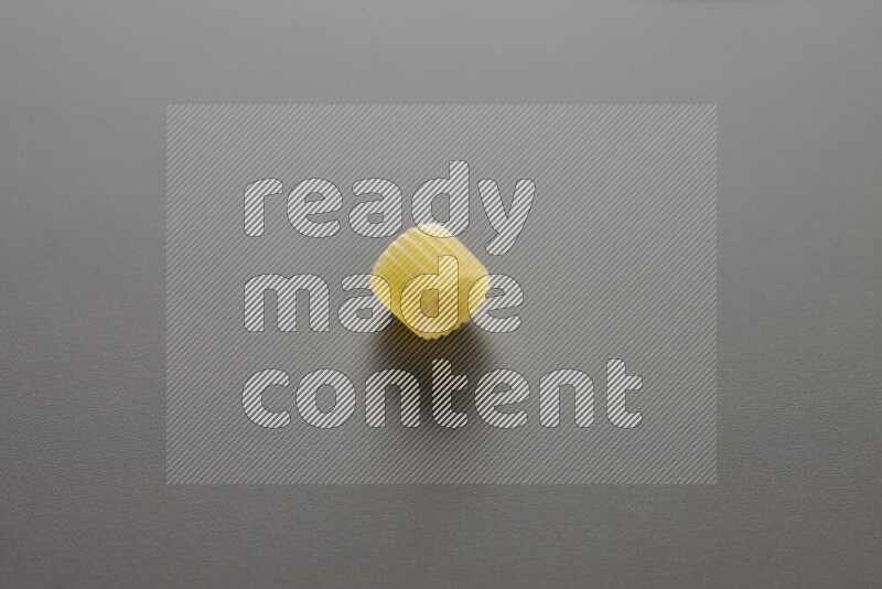 Big rings pasta on grey background