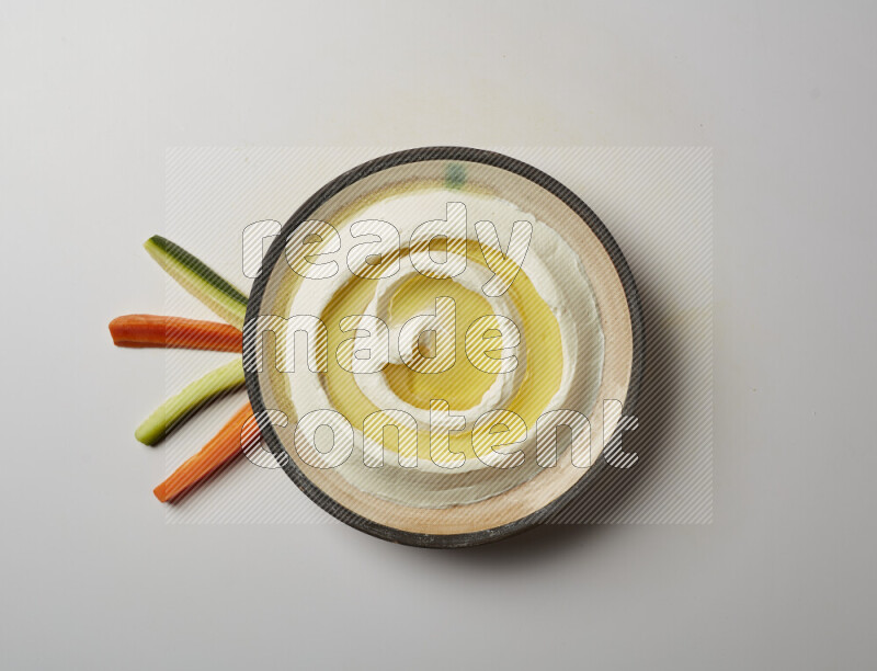 Lebnah garnished with olive oil in a pottery plate on a white background