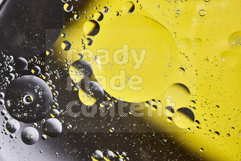 Close-ups of abstract oil bubbles on water surface in shades of yellow and brown