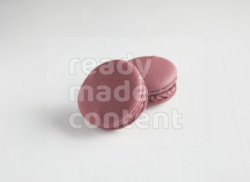 45º Shot of two Red Cherry macarons on white background
