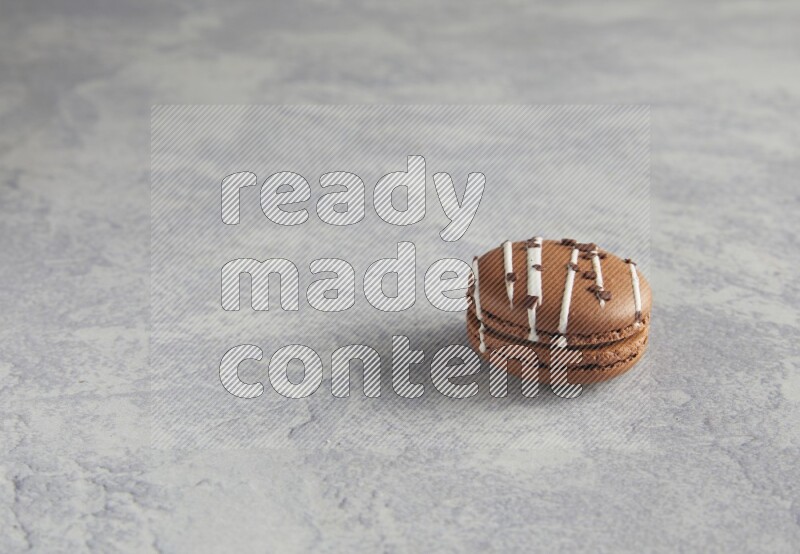 45º Shot of Brown white Chocolate Caramel macaron on white  marble background