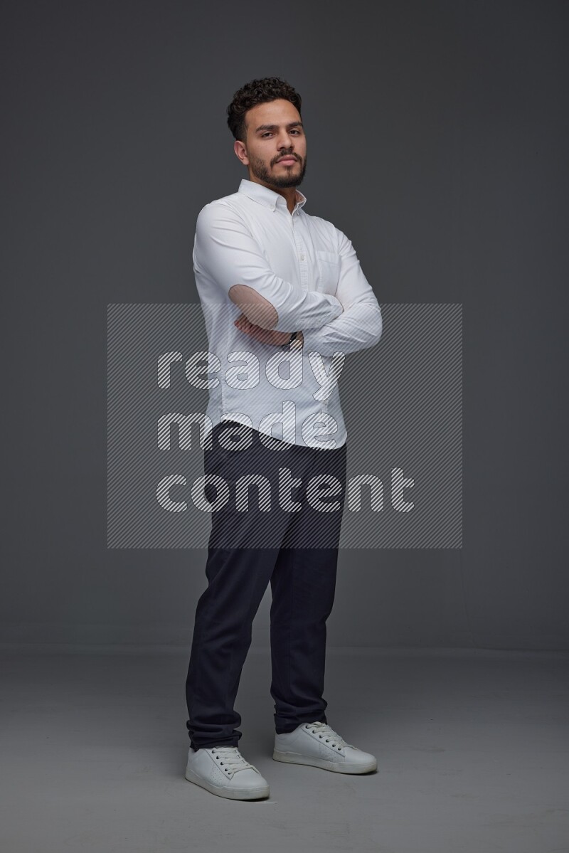 A man wearing smart casual making multi stand poses  eye level on a gray background