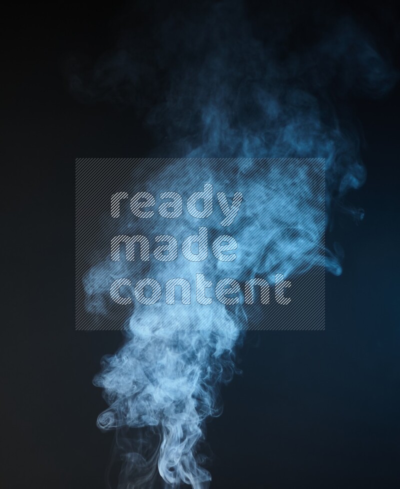 Heavy smoke in blue isolated on black background