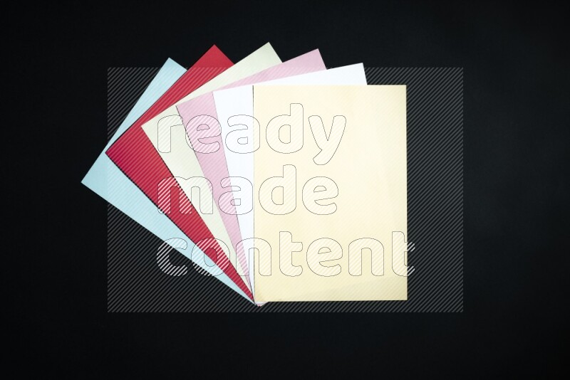 Multicolored paper sheet on black background