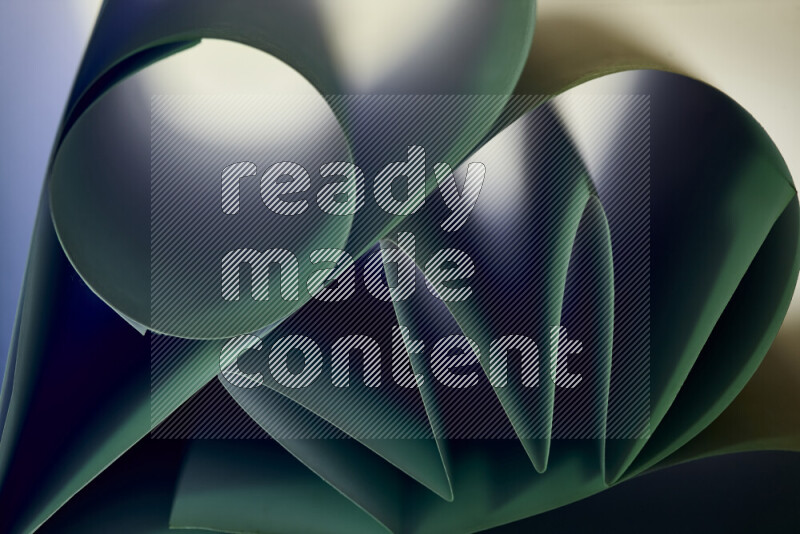 عرض فني لطيات الورق تخلق مزيج من الأشكال الهندسية، مضاءة بإضاءة ناعمة بدرجات اللون الأخضر