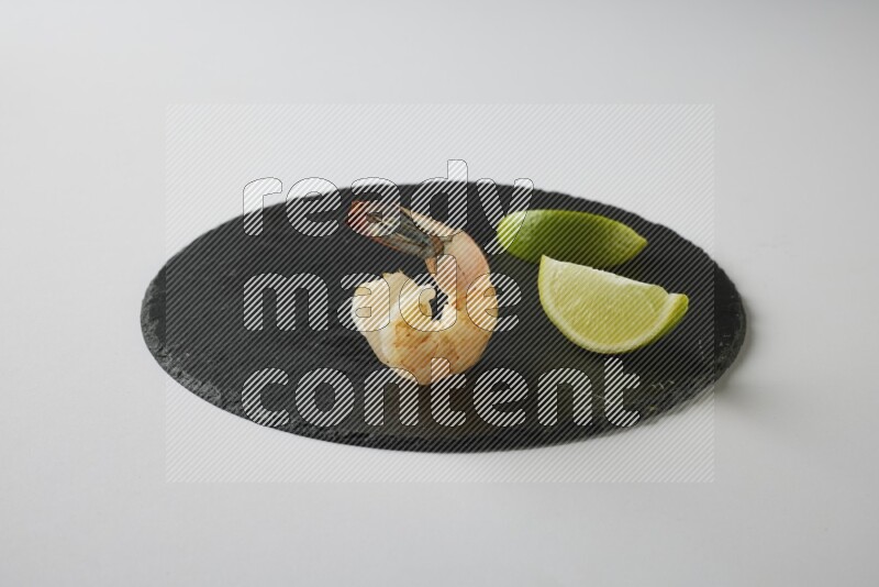 one  grilled shrimp  on a black slate direct  on a white back ground