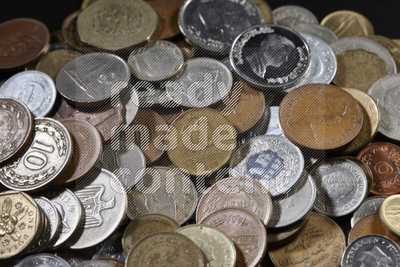 A close-ups of random old coins on black background