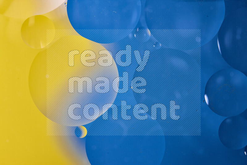 Close-ups of abstract oil bubbles on water surface in shades of blue and yellow