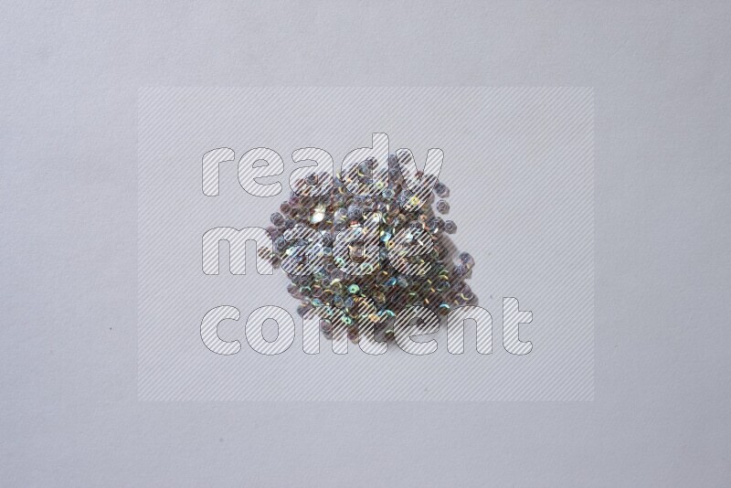 Multicolored flat sequins on grey background