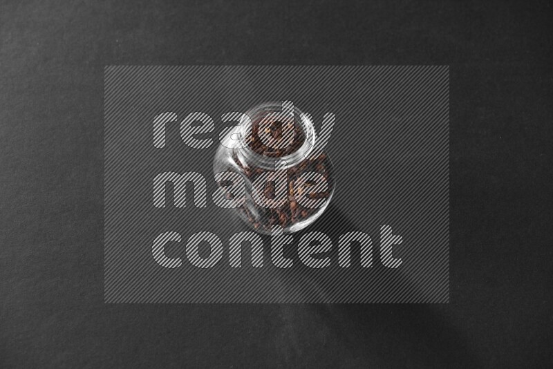 قرنفل في وعاء زجاجي علي خلفية سوداء