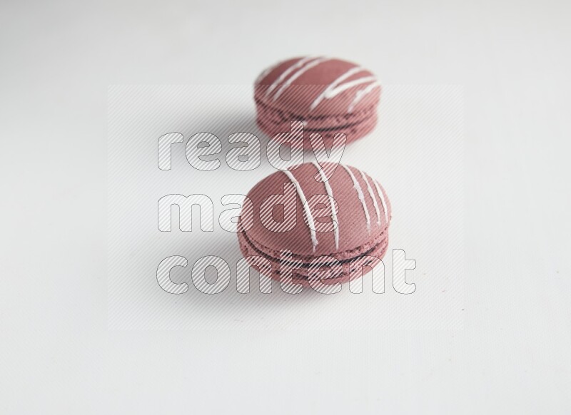 45º Shot of two Red Poppy Flower macarons on white background