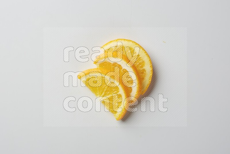 Three halves of an orange slices on white background