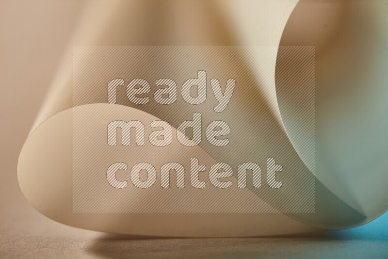 An abstract art piece displaying smooth curves in blue and gold gradients created by colored light