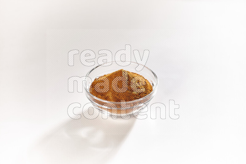 A glass bowl full of ground paprika powder on white background
