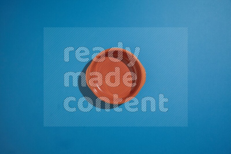 brown bowl on blue background