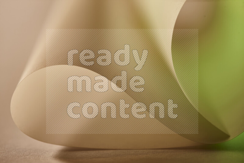 An abstract art piece displaying smooth curves in green and yellow gradients created by colored light