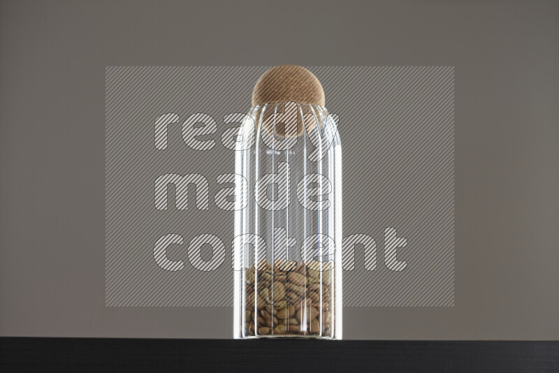 Fava beans in a glass jar on black background