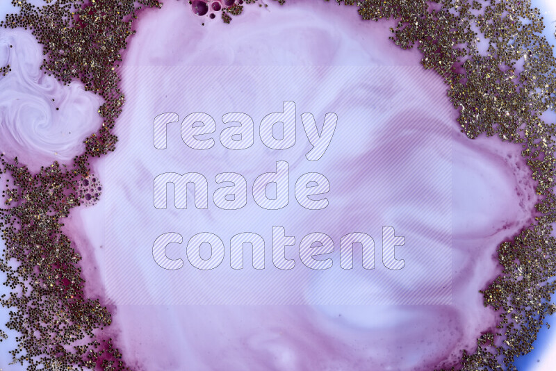 A close-up of sparkling gold glitter scattered on swirling blue and red background