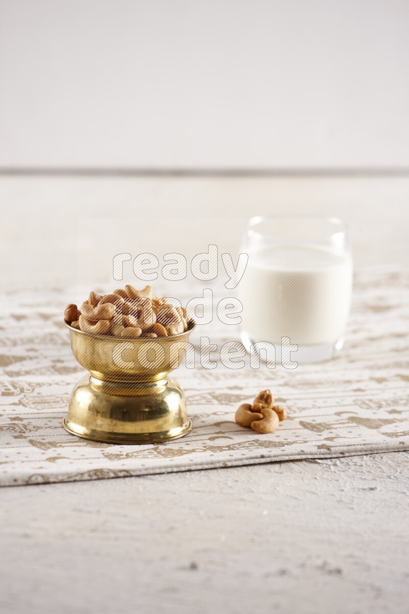 Nuts in a metal bowl with milk a light setup