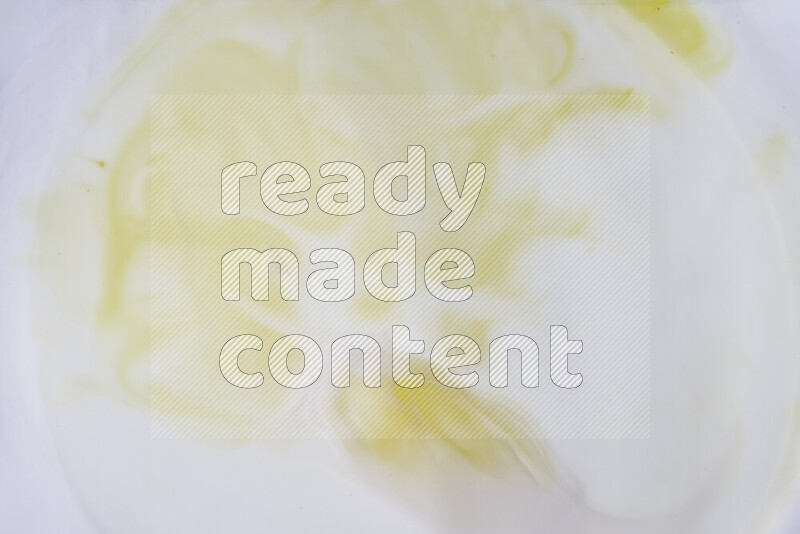 A close-up of abstract swirling patterns in yellow and white