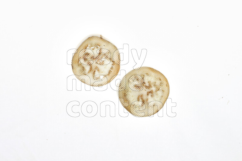 Eggplant slices on illuminated white background