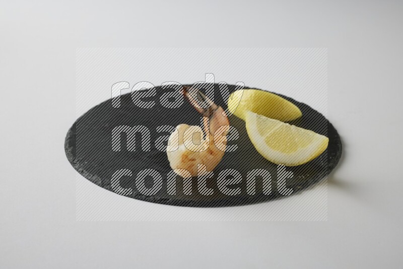 one  grilled shrimp  on a black slate direct  on a white back ground