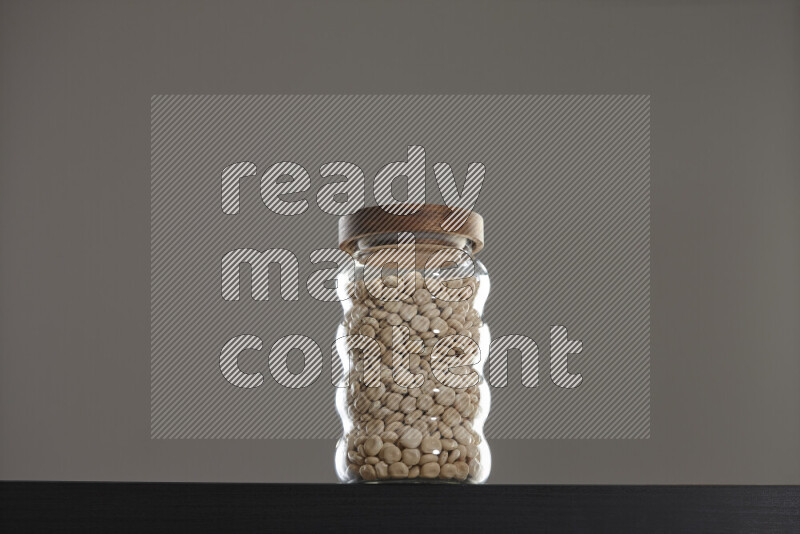 Lupin Beans in a glass jar on black background