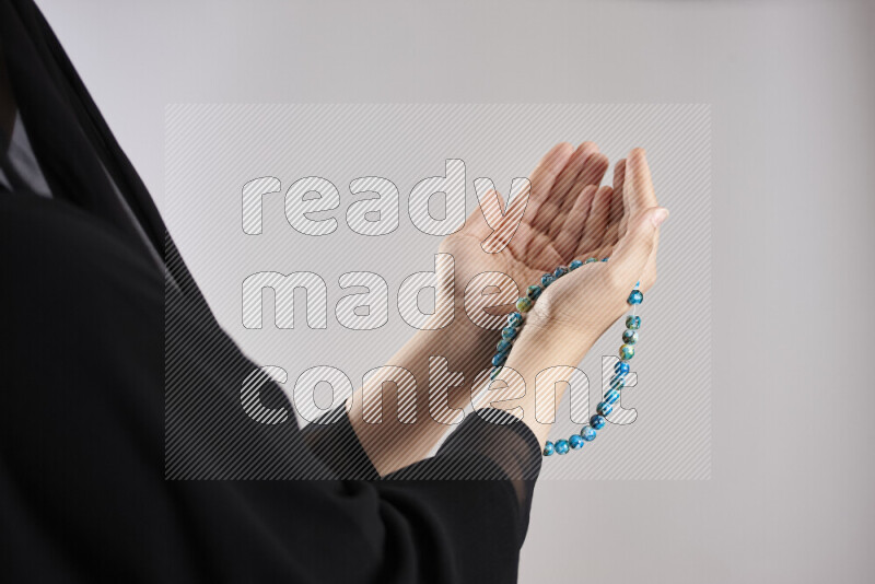 Woman hands holding praying beads (sebha) in different positions