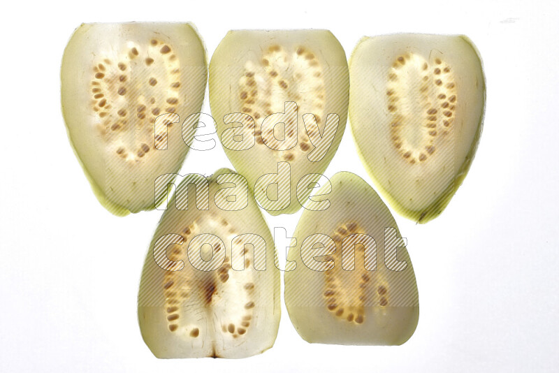 Guava slices on illuminated white background
