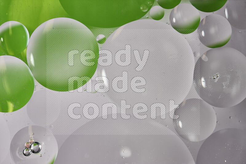 Close-ups of abstract oil bubbles on water surface in shades of white and green