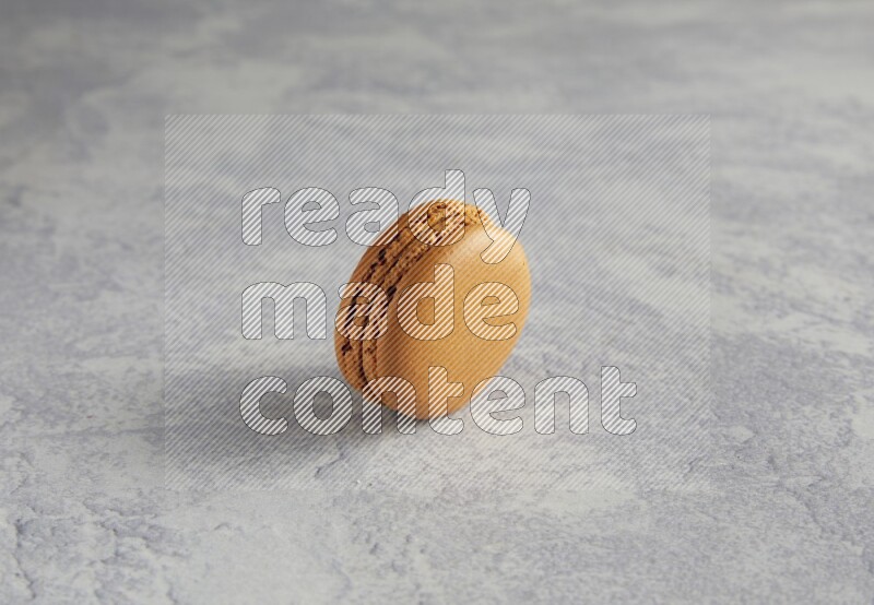 45º Shot of Brown Maple Taffy macaron on white  marble background
