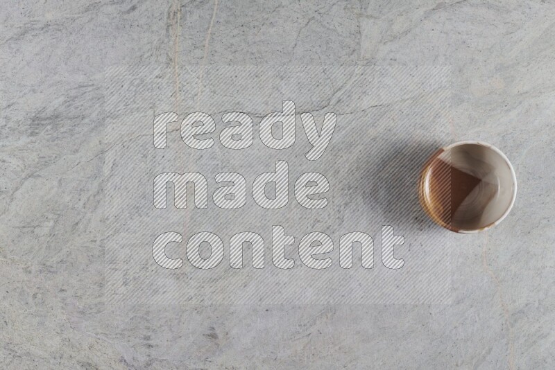 A multicolored pottery Bowl on grey marble background