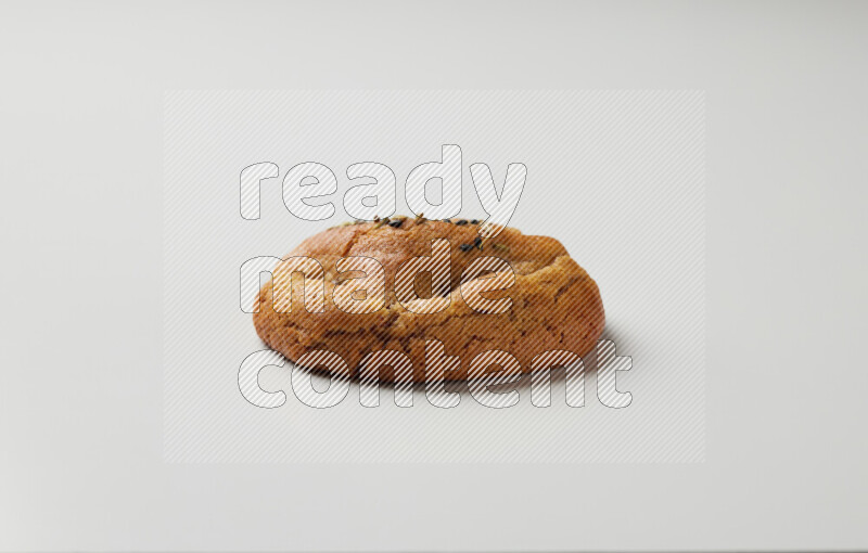 Hasawi cookie field with date and decorated by black seed and Anise grain on a white background