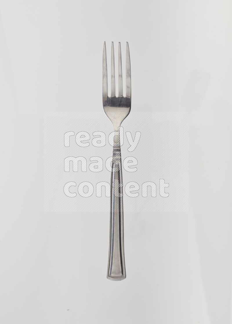Silver stainless steel fork on white background