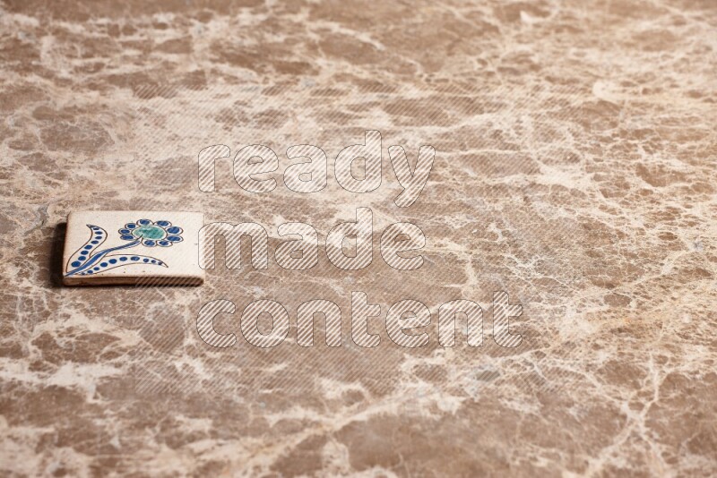 A decorative coaster on beige marble background