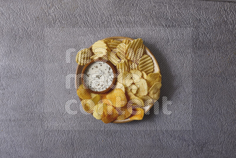 Assorted snacks in pottery bowls on grey background